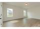 Spacious bedroom with wood-look floors, neutral walls, and two windows at 1266 Langston Ln, Salisbury, NC 28144