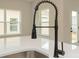 A close up of the kitchen sink and faucet on the island in the kitchen with stainless steel appliances at 1266 Langston Ln, Salisbury, NC 28144