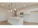 Modern kitchen features white cabinets, quartz countertops, stainless steel appliances, and pendant lighting at 1266 Langston Ln, Salisbury, NC 28144