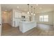 Open kitchen features white cabinets, an island with a sink, pendant lighting, and stainless steel appliances at 1266 Langston Ln, Salisbury, NC 28144