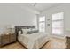 Bright bedroom featuring hardwood floors, neutral tones, and a large bed with decorative pillows, great for relaxation at 1315 East Blvd # 225, Charlotte, NC 28203