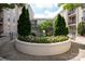 Lush courtyard featuring manicured greenery, flowers, and mature trees, surrounded by apartment buildings at 1315 East Blvd # 225, Charlotte, NC 28203