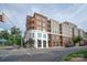 A view of the building exterior, featuring a combination of brick and white facade with balconies at 1315 East Blvd # 225, Charlotte, NC 28203
