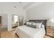 Bright main bedroom with hardwood floors, neutral tones, and a large bed with decorative pillows at 1315 East Blvd # 225, Charlotte, NC 28203