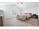 Bright bedroom features a queen bed, sofa, and a large window with natural light at 1343 Kent Downs Sw Ave, Concord, NC 28027