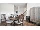 Warm dining area with a wooden table and chairs, complemented by a wine cooler at 1343 Kent Downs Sw Ave, Concord, NC 28027