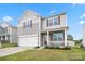 Inviting two-story home featuring a cozy front porch, attached garage, and well-maintained lawn at 1343 Kent Downs Sw Ave, Concord, NC 28027