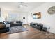 Stylish living room featuring sleek furnishings, a large sectional, and a modern entertainment center at 1343 Kent Downs Sw Ave, Concord, NC 28027