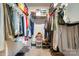 Well-organized walk-in closet providing ample storage space for clothing and accessories at 1343 Kent Downs Sw Ave, Concord, NC 28027
