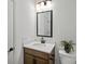 Modern bathroom vanity with sleek black hardware, quartz countertop, and stylish lighting fixture at 1532 Gossage Nw Ln, Concord, NC 28027
