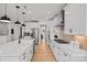 Long kitchen with stainless steel appliances and white cabinetry at 1532 Gossage Nw Ln, Concord, NC 28027