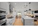 Open-concept kitchen with modern appliances, island, and seamless flow to dining and living areas at 1532 Gossage Nw Ln, Concord, NC 28027