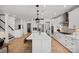 Bright, open kitchen with white cabinetry, a large island, and stainless steel appliances at 1532 Gossage Nw Ln, Concord, NC 28027