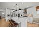 Open-concept kitchen featuring white cabinets, quartz countertops, and a stylish backsplash at 1532 Gossage Nw Ln, Concord, NC 28027