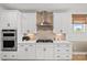 Modern kitchen with stainless steel appliances, white cabinets, and stylish tile backsplash at 1532 Gossage Nw Ln, Concord, NC 28027