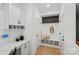 Inviting mudroom with built-in bench, coat hooks, and ample storage cabinets at 1532 Gossage Nw Ln, Concord, NC 28027