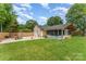 Large backyard featuring a home with a framed sunroom addition, offering ample outdoor space at 157 Downey Lake Rd, Dallas, NC 28034