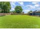 Lush backyard with a tall wood fence, featuring a storage building and a tidy lawn at 157 Downey Lake Rd, Dallas, NC 28034