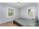 Cozy bedroom with hardwood floors, gray walls, and natural light from two windows at 157 Downey Lake Rd, Dallas, NC 28034