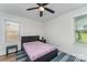 Bright bedroom with ceiling fan, large window and light walls and flooring at 157 Downey Lake Rd, Dallas, NC 28034