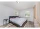 Bedroom with modern gray bedframe, hardwood flooring, and side tables with lamps at 157 Downey Lake Rd, Dallas, NC 28034