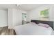 Bedroom with modern gray bedframe, hardwood flooring, and side tables with lamps at 157 Downey Lake Rd, Dallas, NC 28034