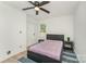 Bright bedroom with ceiling fan, large window and light walls and flooring at 157 Downey Lake Rd, Dallas, NC 28034