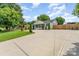Spacious home with large driveway, lush lawn, mature trees, and wood privacy fence at 157 Downey Lake Rd, Dallas, NC 28034