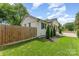 Well-maintained home exterior with a wood privacy fence and manicured lawn at 157 Downey Lake Rd, Dallas, NC 28034