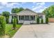 Charming white brick home featuring a covered porch and well-manicured landscaping at 157 Downey Lake Rd, Dallas, NC 28034