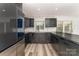 Modern kitchen showcasing dark cabinetry, stainless steel appliances, and an eat-in bar at 157 Downey Lake Rd, Dallas, NC 28034