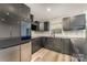 Updated kitchen with modern appliances, sleek dark cabinets, and eat-in bar area at 157 Downey Lake Rd, Dallas, NC 28034