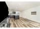Open-concept space with hardwood floors connecting to kitchen with bar seating at 157 Downey Lake Rd, Dallas, NC 28034