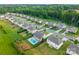 Aerial view of a neighborhood with mature trees, manicured lawns, and a pool in a private backyard at 163 Sassafras Rd, Mooresville, NC 28115