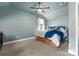 Carpeted bedroom with ceiling fan and a large window for natural light at 163 Sassafras Rd, Mooresville, NC 28115