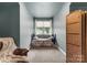 Cozy carpeted bedroom with a window and a woven folding screen at 163 Sassafras Rd, Mooresville, NC 28115