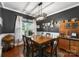 Dining area featuring dark walls, wooden table set, and large windows for natural light at 163 Sassafras Rd, Mooresville, NC 28115