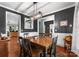 Elegant dining room with wooden table, gray walls with white trim, and vintage decor at 163 Sassafras Rd, Mooresville, NC 28115