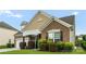 Brick home with a well manicured lawn and covered front porch at 163 Sassafras Rd, Mooresville, NC 28115