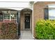 Close-up of a charming front door framed by brick, a black post, and vibrant landscaping, creating curb appeal at 163 Sassafras Rd, Mooresville, NC 28115