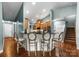 Open-concept kitchen features a breakfast bar with modern bar stools and wood flooring at 163 Sassafras Rd, Mooresville, NC 28115