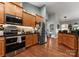 Well-lit kitchen boasts stainless steel appliances, wood cabinets, and dark countertops at 163 Sassafras Rd, Mooresville, NC 28115