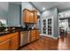 Kitchen with stainless steel appliances, wood cabinets, and a pantry behind glass doors at 163 Sassafras Rd, Mooresville, NC 28115