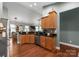 Bright, open kitchen with stainless steel appliances, wood cabinets, and a breakfast bar at 163 Sassafras Rd, Mooresville, NC 28115