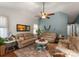 Cozy living room featuring plush sofas, a ceiling fan, and decorative accents perfect for relaxing or entertaining guests at 163 Sassafras Rd, Mooresville, NC 28115