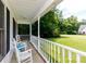 Inviting front porch with classic rocking chairs and a view of the landscaped yard at 1636 Springwinds Dr, Rock Hill, SC 29730
