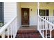 Inviting front porch with white railings and a beautiful wood door with decorative glass at 1636 Springwinds Dr, Rock Hill, SC 29730