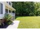 Well maintained front yard with lush green grass and mature trees and landscaping at 1636 Springwinds Dr, Rock Hill, SC 29730