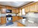 Well-equipped kitchen with wood cabinets, granite countertops, and modern appliances at 1636 Springwinds Dr, Rock Hill, SC 29730