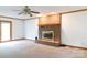 Cozy living room featuring a traditional fireplace with brick surround and a ceiling fan at 1636 Springwinds Dr, Rock Hill, SC 29730
